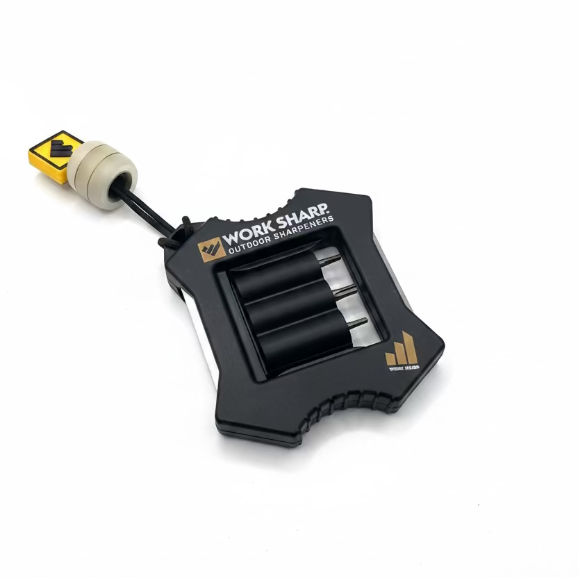 Work Sharp outdoor sharpeners with a black body, gold logo accents, and a beige and yellow handle, shown on a plain light gray background.